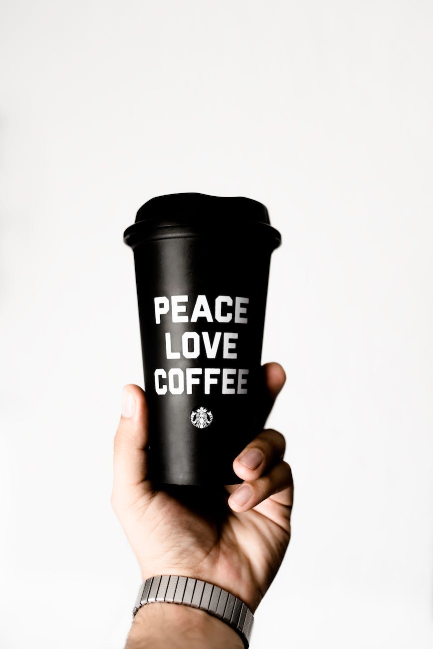 person holding starbucks coffee tumbler